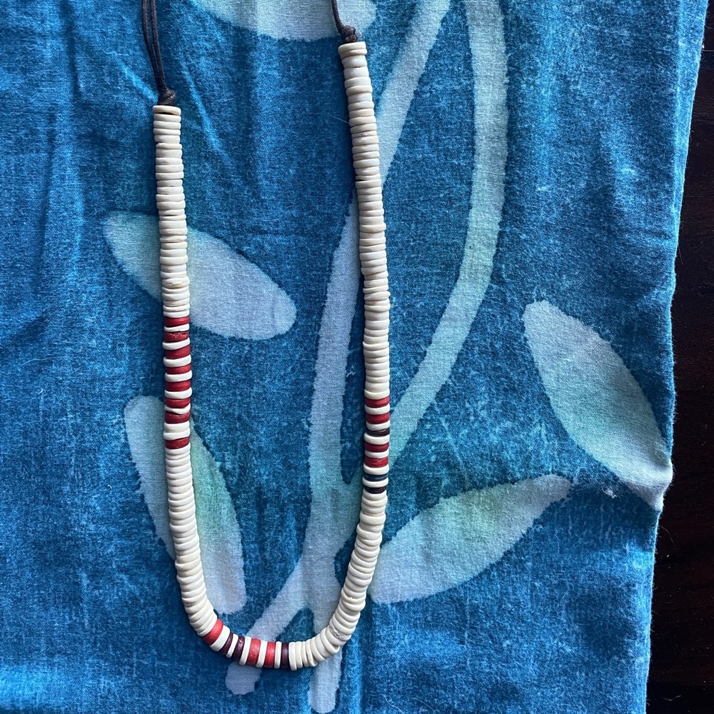 adjustable necklace reminiscent of 1970’s puka shells.